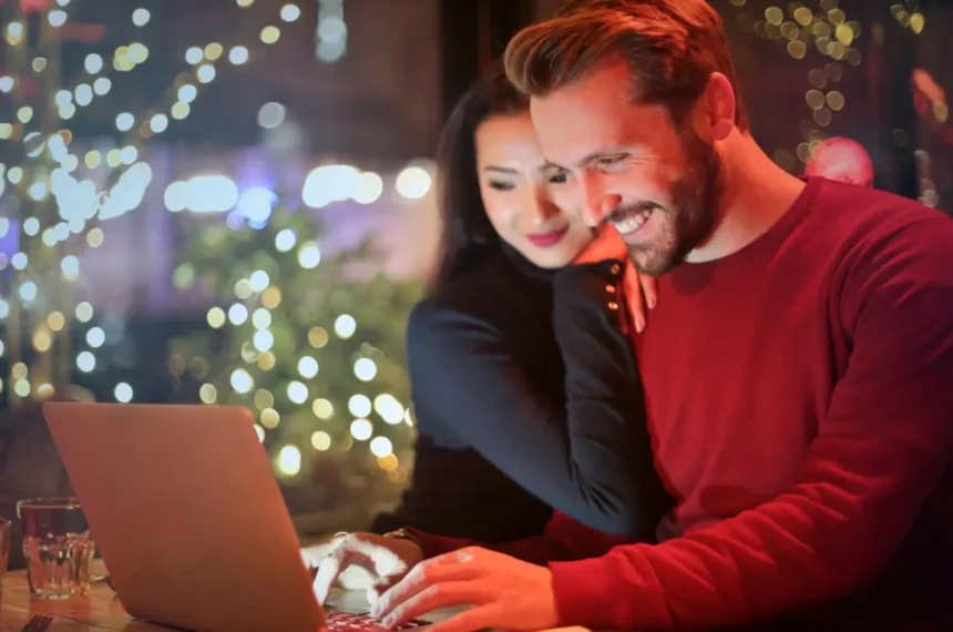 Happy couple shopping online on laptop