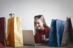 A woman shopping online using her laptop and credit card. The Future of Customer Experience in 2025 and Beyond