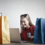 A woman shopping online using her laptop and credit card. The Future of Customer Experience in 2025 and Beyond