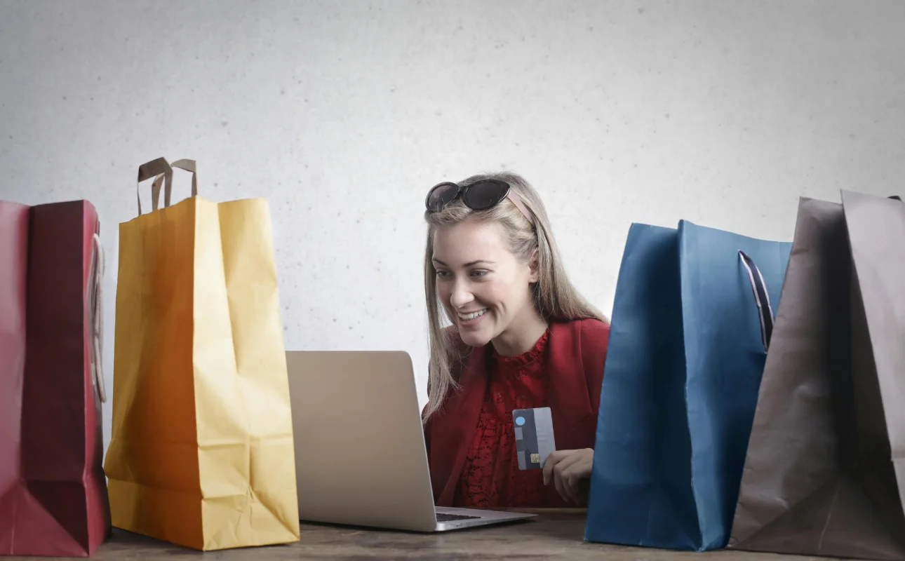 A woman shopping online using her laptop and credit card. The Future of Customer Experience in 2025 and Beyond