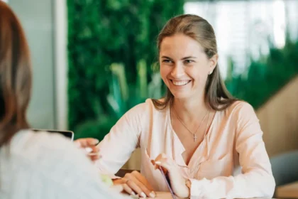 UX Designer Taking User Feedback. Two women sitting across the table and talking.